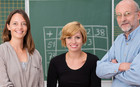 Zwei Lehrerinnen und ein Lehrer nebeneinander vor grüner Tafel.