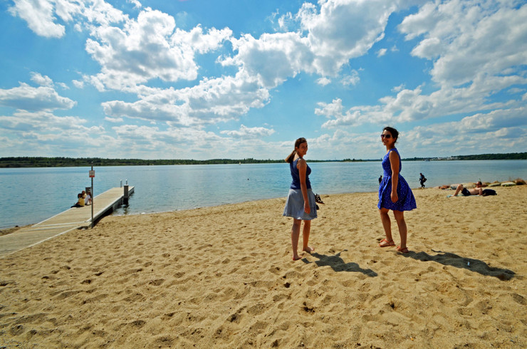 Zwei Frauen an einem Sandstrand am See