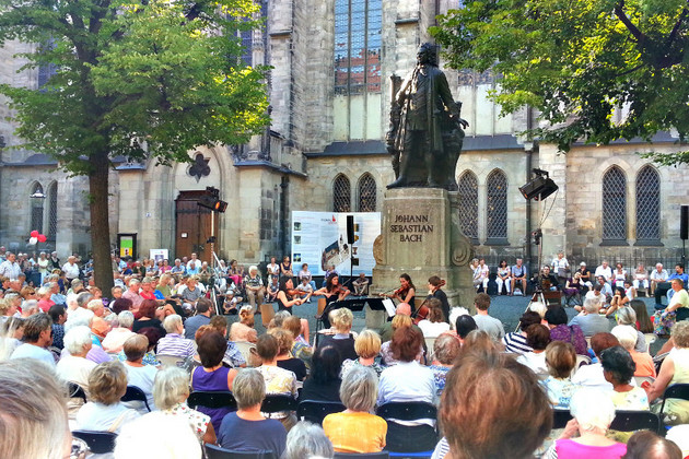Zuschauer hören Musiker am Bachdenkmal vor der Thomaskirche zu