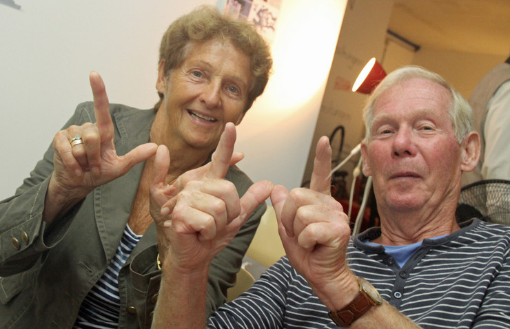 2 Senioren bilden mit ihren Händen ein Willkommens-W
