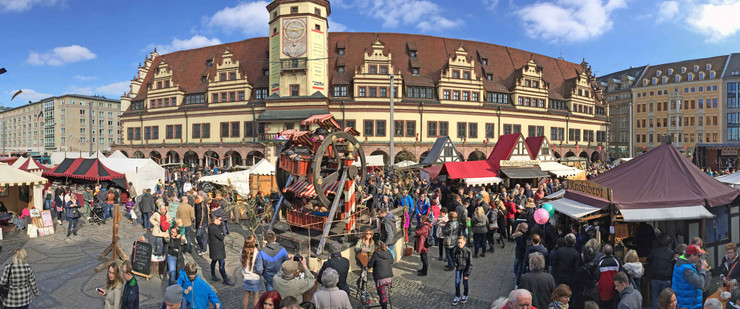 Viele Marktstände und historisches Holzriesenrad zum Ostermarkt auf dem Markt vor dem Alten Rathaus