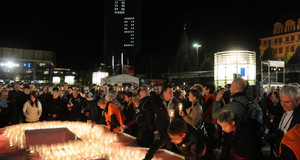 Viele Besucher auf dem Augustusplatz beim Lichtfest. Aus Kerzen wird eine 89 geformt.